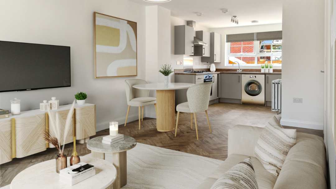 Open-plan apartment living space with a sofa, a coffee table, a dining table and two dining chairs, a kitchen, and decorative wall art 