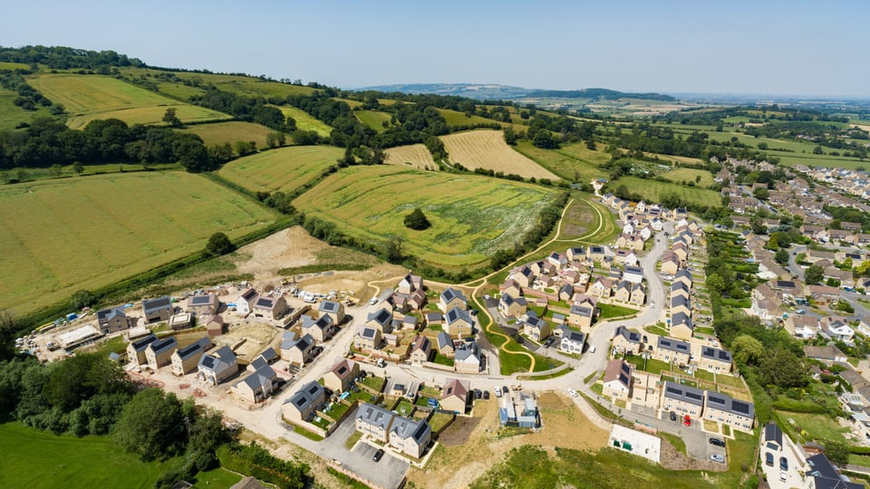 Aerial view of Merret Place development with surrounding countryside.